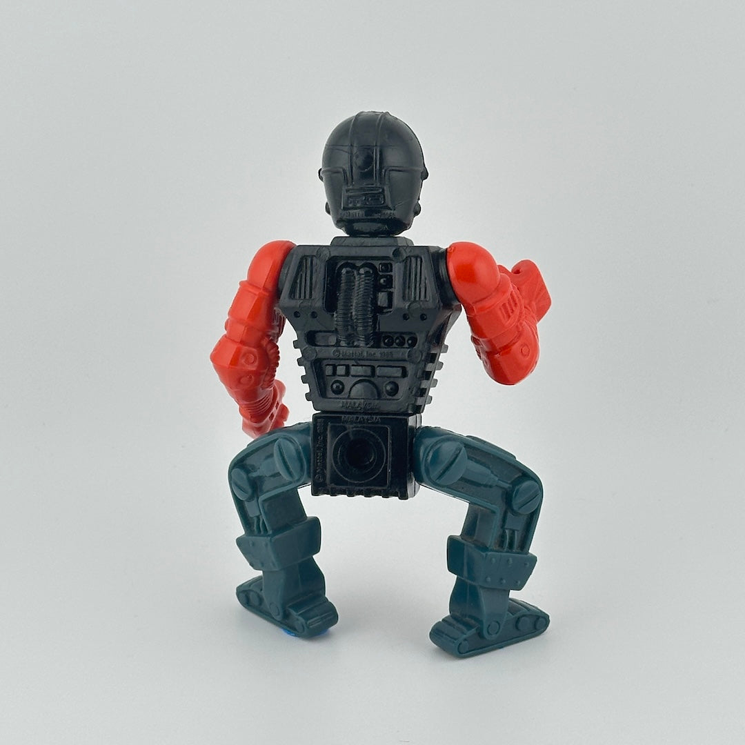 Robotic figure with red arms, blue legs, black waist, silver chest, black helmet, with green face.