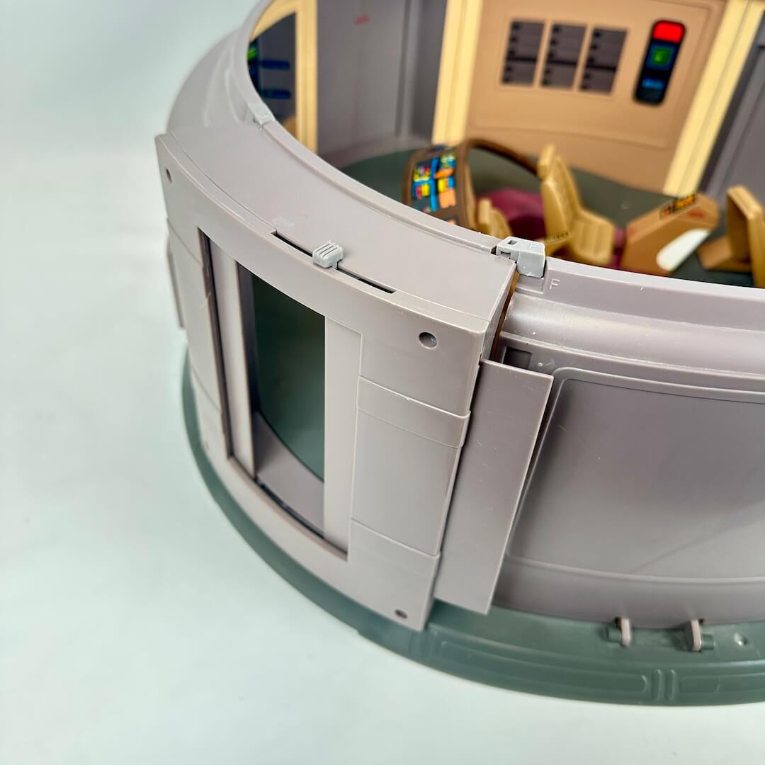 Toy spaceship model with detailed interior on a light blue background