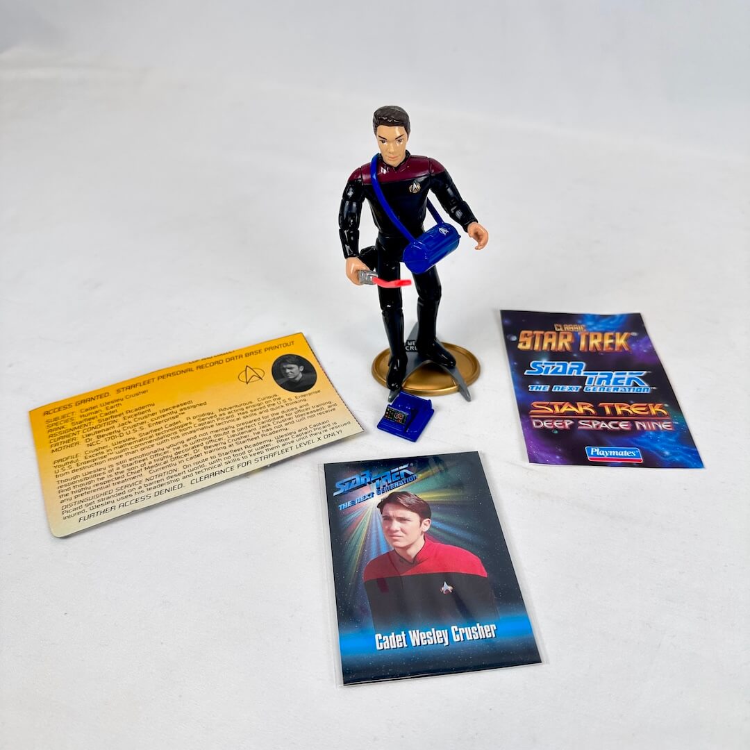 Star Trek action figure with related materials on a white background