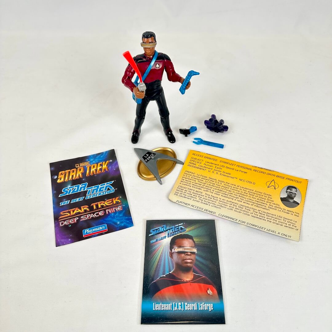 Star Trek action figure with accessories and cards on a white background