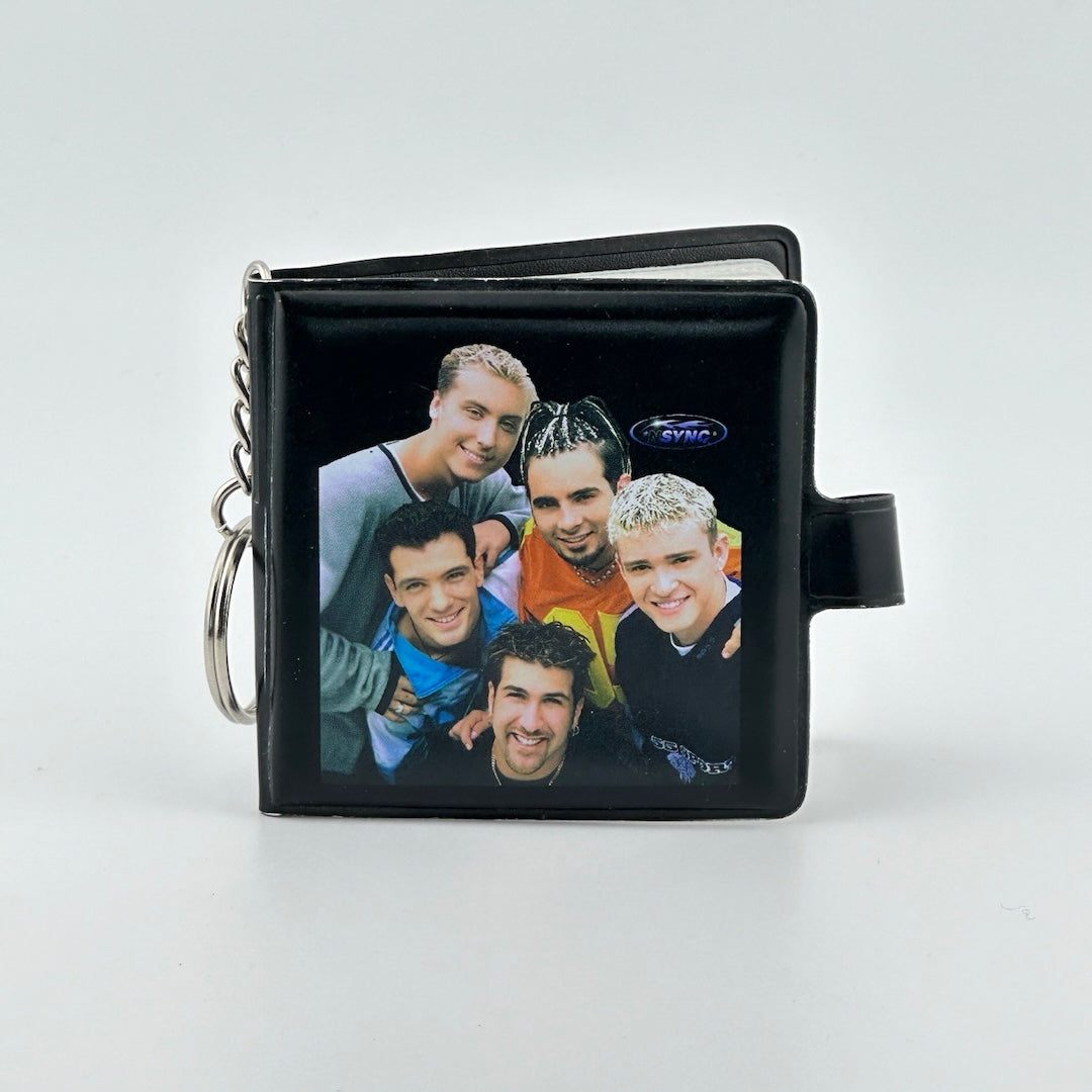 Black book with keychain attachment, snap closure, & image of five members of NYSNC.