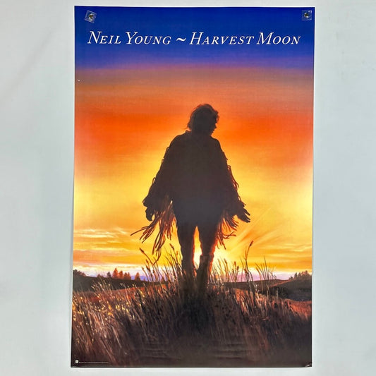 Poster of Neil Young's 'Harvest Moon' album with a silhouette against a sunset sky.