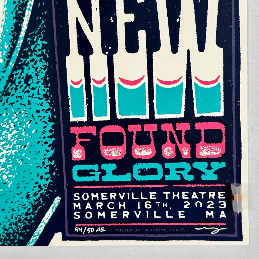 Close up of event info in bottom right corner, no damage to edges or corner. Text in pink, blue & white.