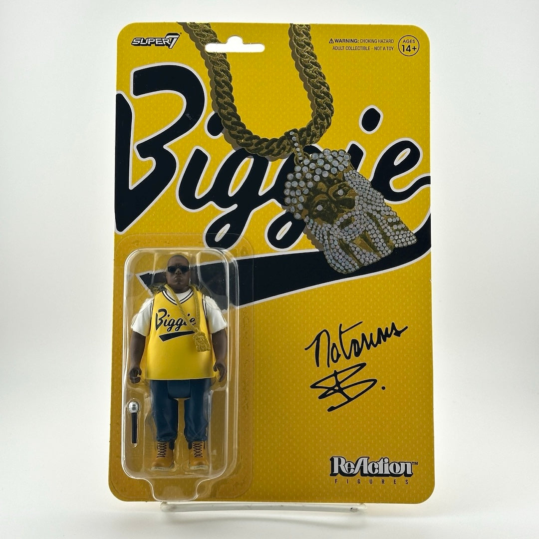 Yellow backing card with clear plastic blister containing figure of Biggie in yellow jersey & jeans with chain & microphone.