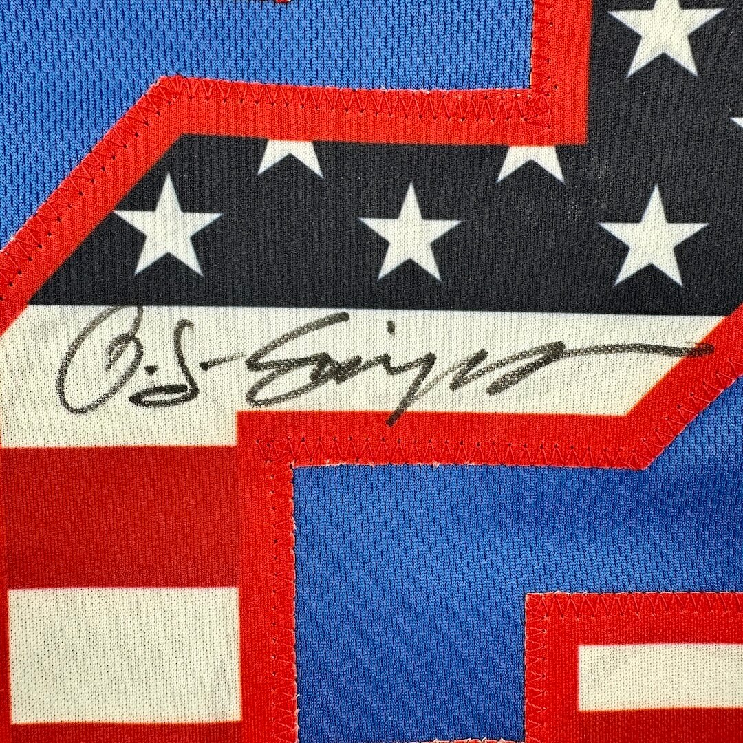 Close-up of a USA flag printed number with a signature in the center