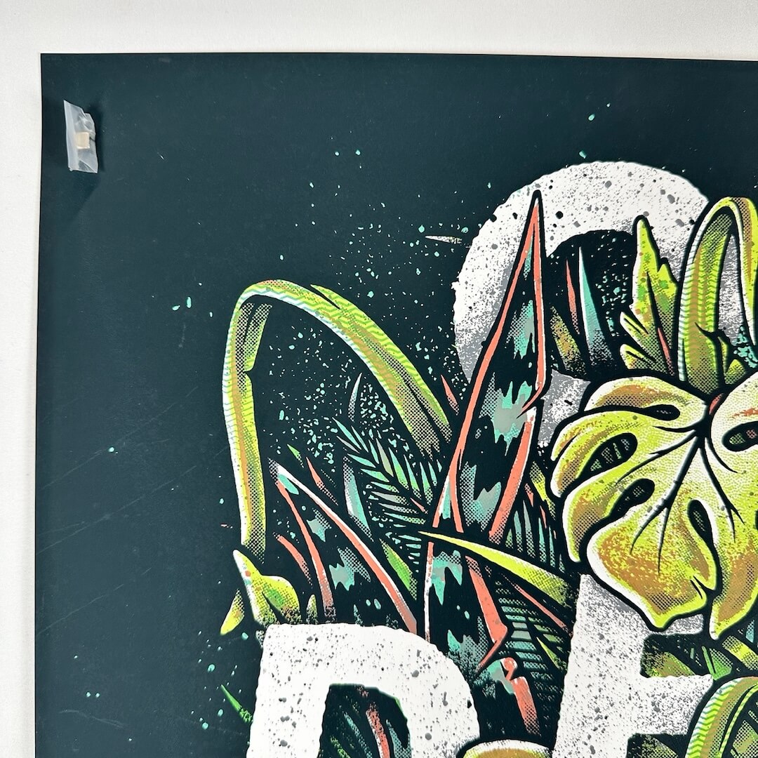 Top left corner of poster showing crisp corner and no edge wear. Some scratches to ink visible along edge.