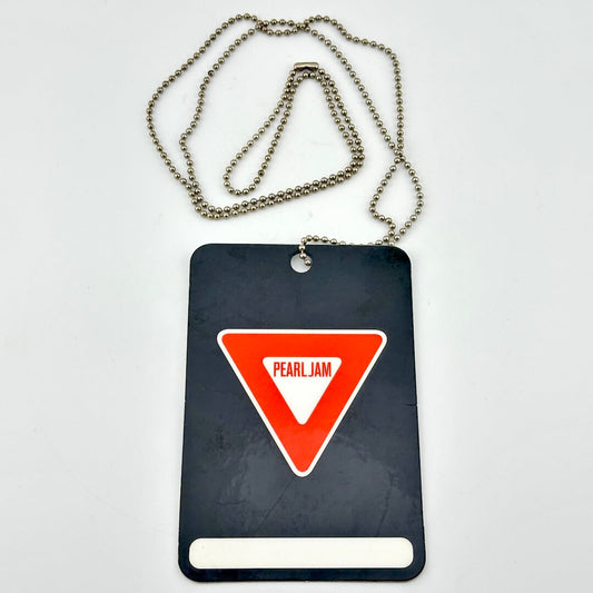 Black card with red triangle and 'Pearl Jam' logo on a white background
