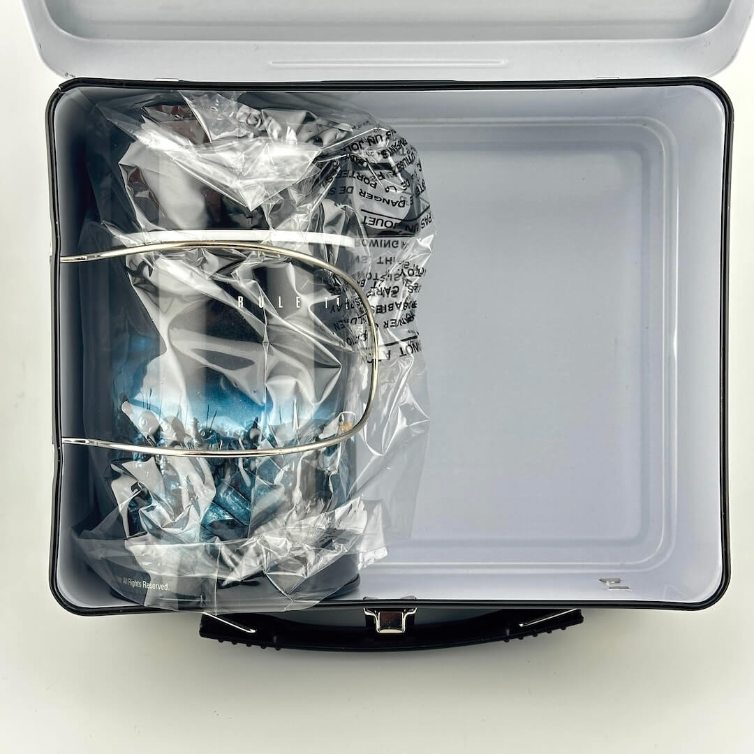 View of interior of metal lunchbox showing matching thermos in original plastic wrap.