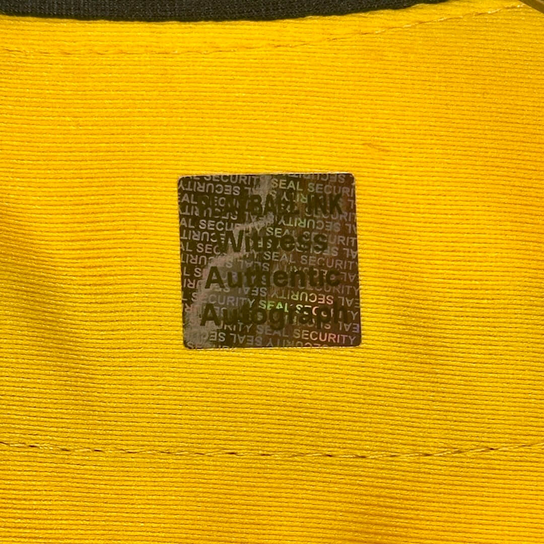 Close up of holographic authentication sticker, "Playball Ink Witness Authentic Autograph"