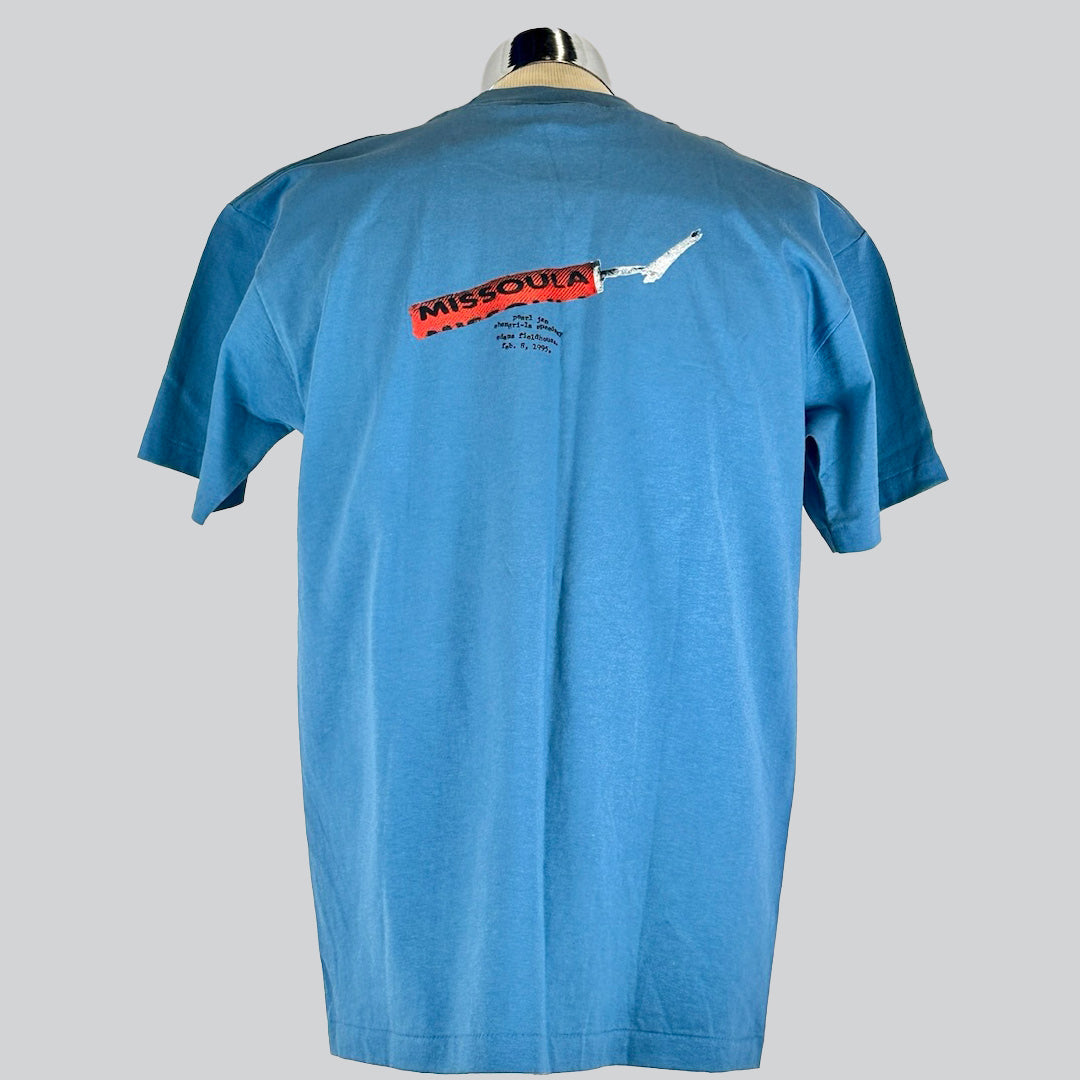 Back of blue Pearl Jam T-shirt featuring a firecracker that reads 'Missoula' with a concert date 1995.