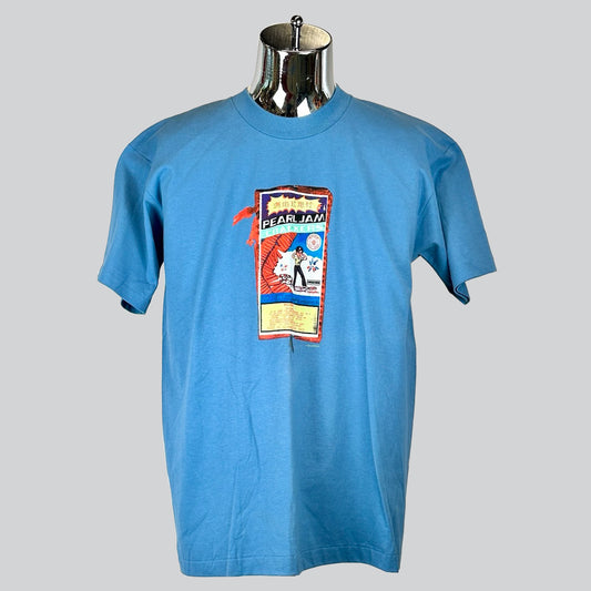 Blue Pearl Jam T-shirt with colorful concert-themed graphic, featuring stylized text and imagery in a vintage concert poster style.