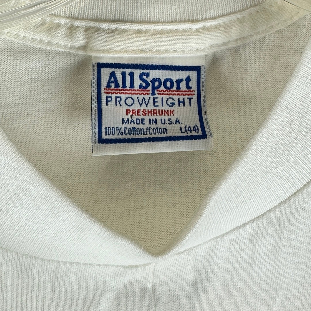 Close-up of the tag on a Pearl Jam t-shirt, showing size, material, and care instructions.