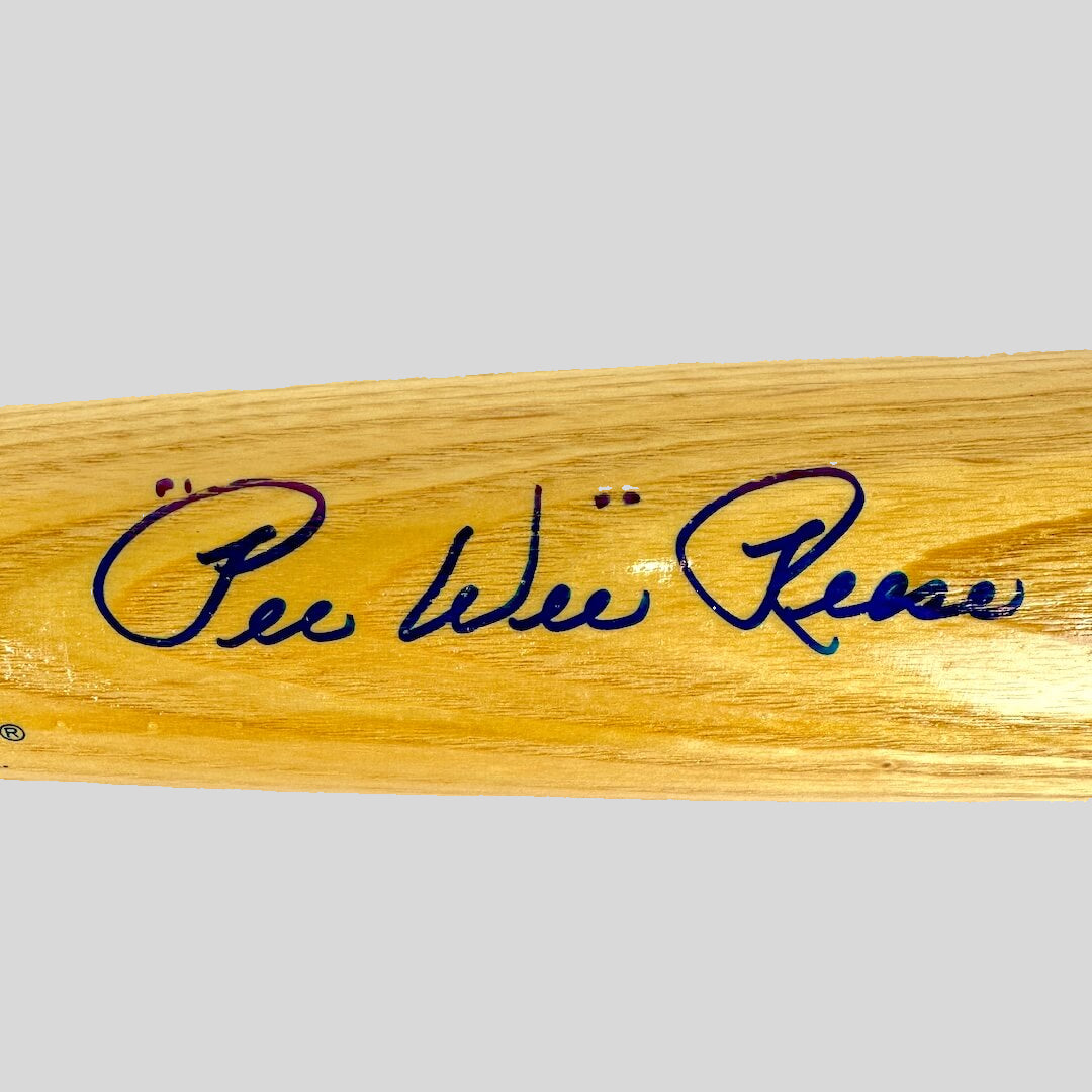 Wooden bat with blue signature on a beige background