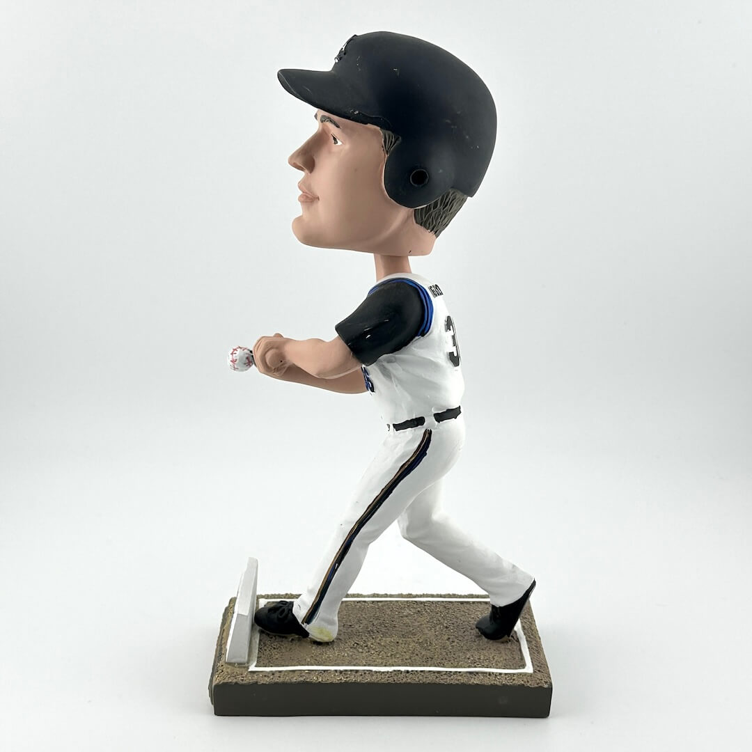 Bobblehead of a baseball player in a white uniform with black helmet on a white background