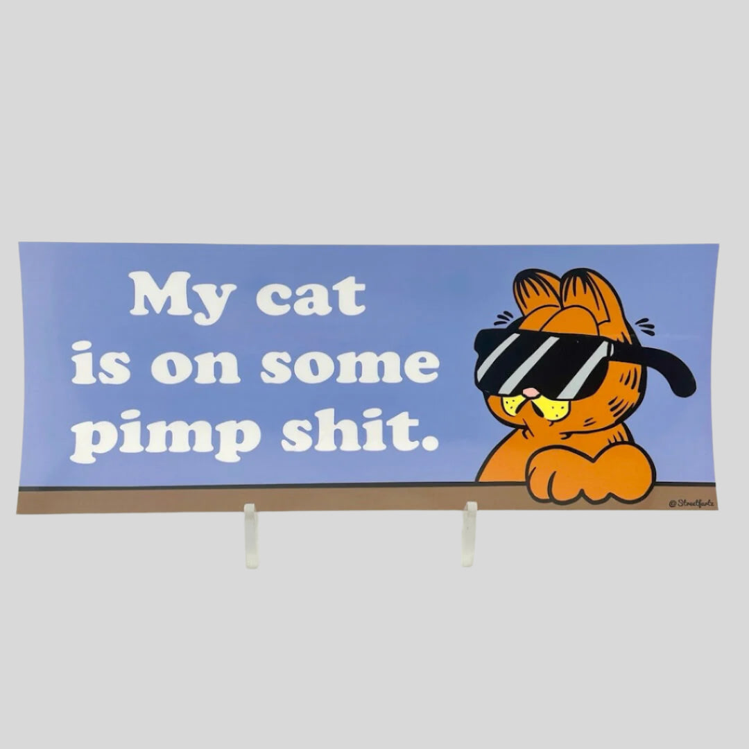 Periwinkle background sticker with Garfield the cat wearing sunglasses next to white text, "My cat is on some pimp shit."