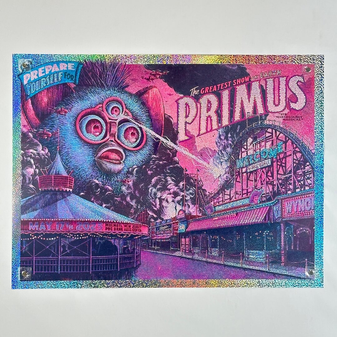 Glitter foil concert poster for Primus with a large blue Furby attacking amusement park, and vibrant text.