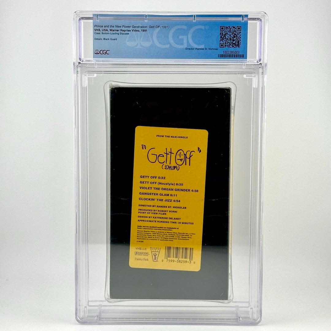 Image of sealed VHS tape in clear plastic case with grading info at top. VHS is black with yellow label with purple print.