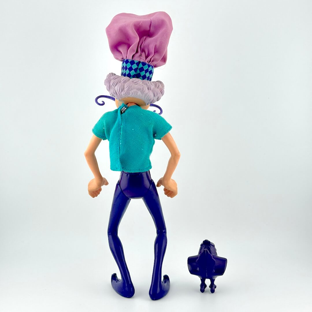 Toy figure of a character with a chef hat and blue outfit on a white background