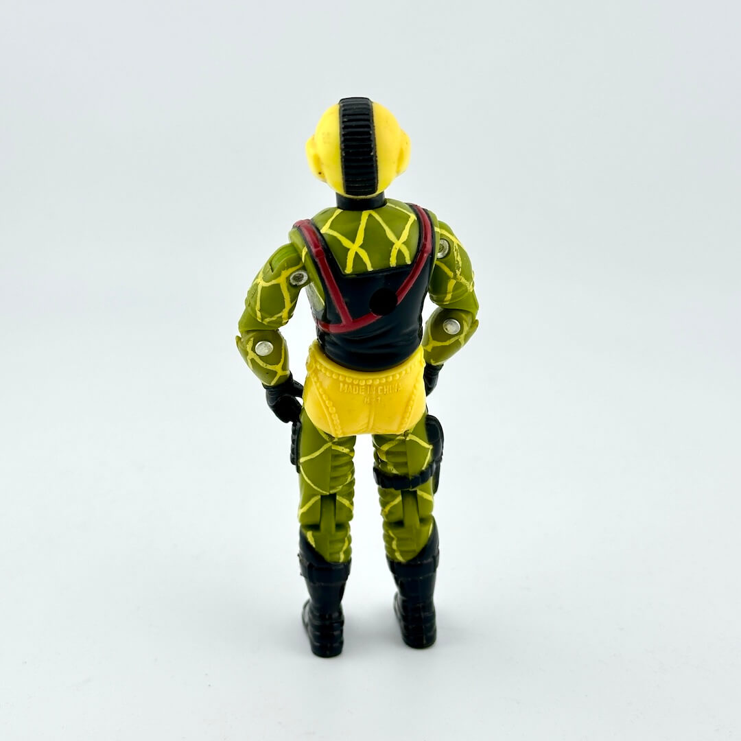Toy figure in a green and yellow outfit with black boots on a white background