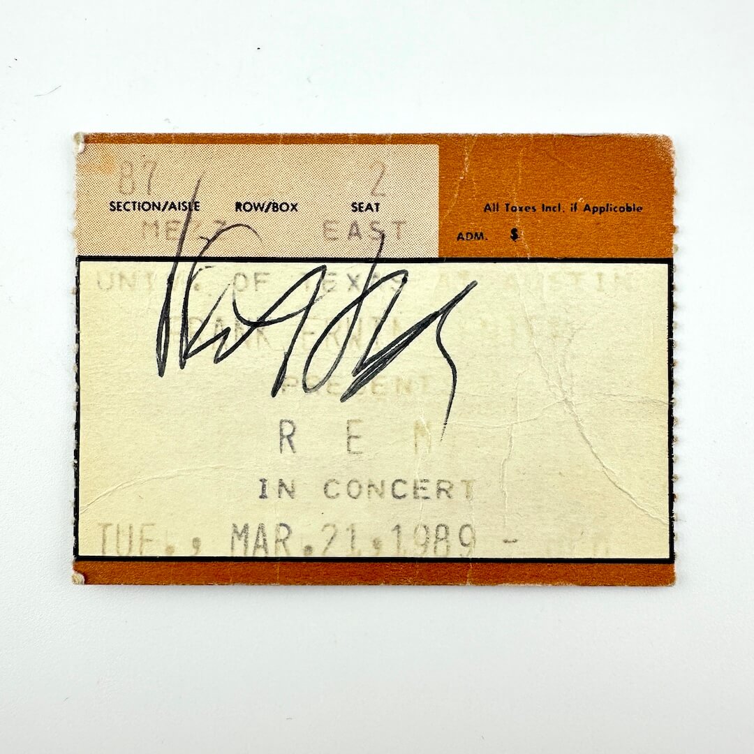 Vintage concert ticket with signature on a white background