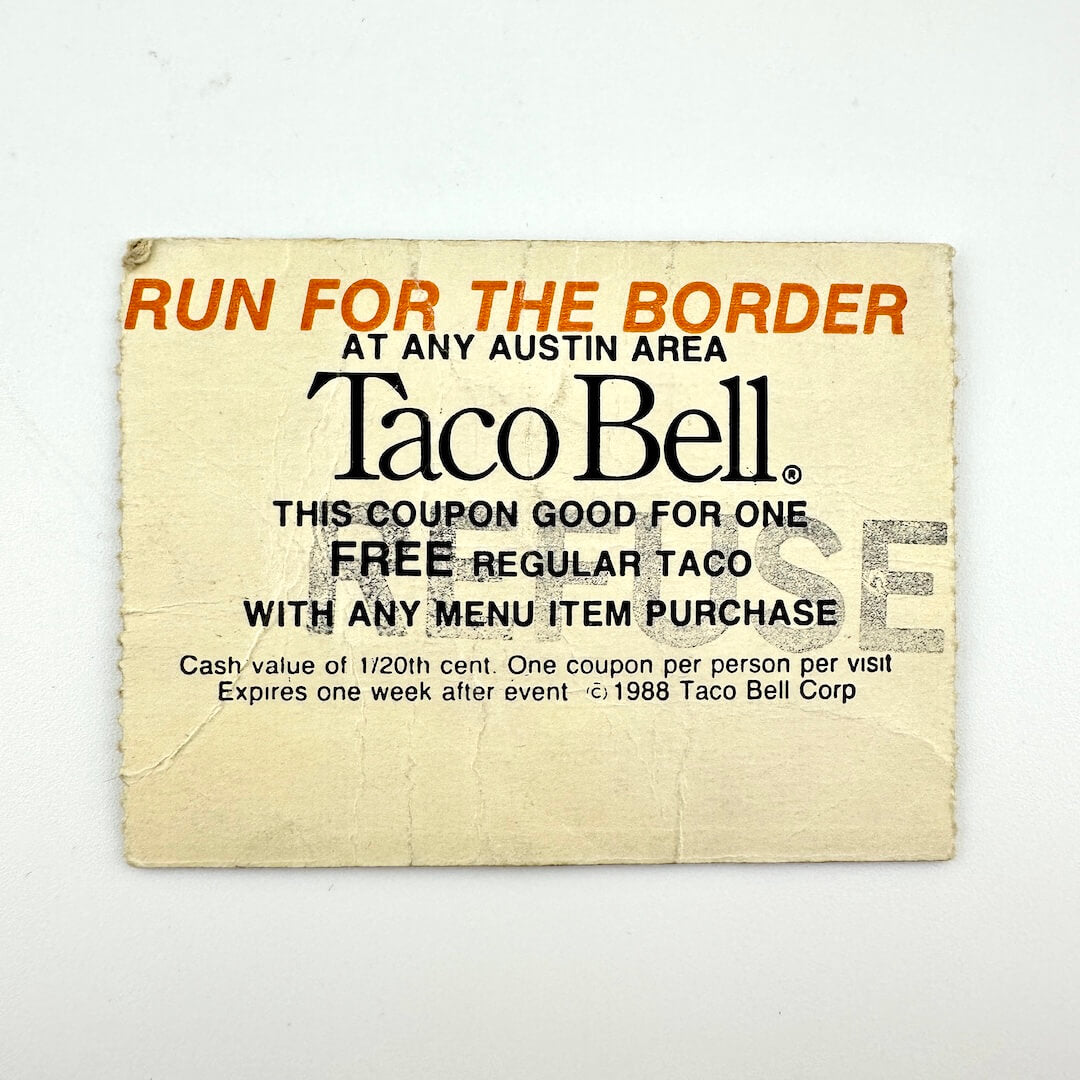 Taco Bell coupon for a free regular taco with any menu item purchase, on a white background.