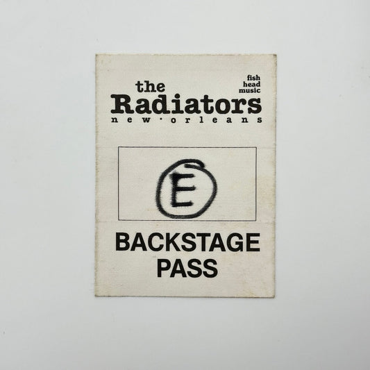 White rectangular fabric backstage pass with black print with event information in basic text, circled "e" in center.
