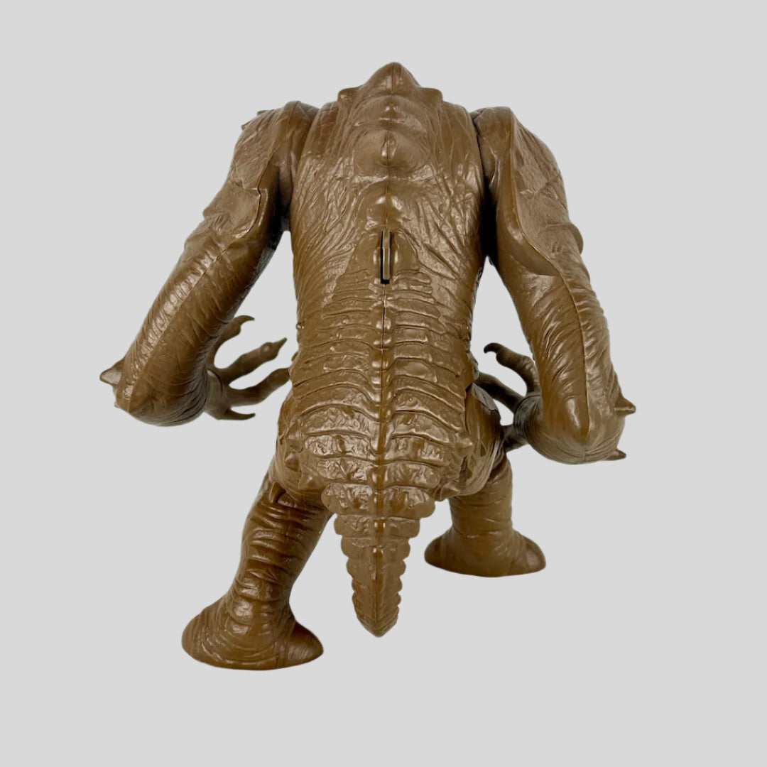 Brown toy figure of a creature on a white background