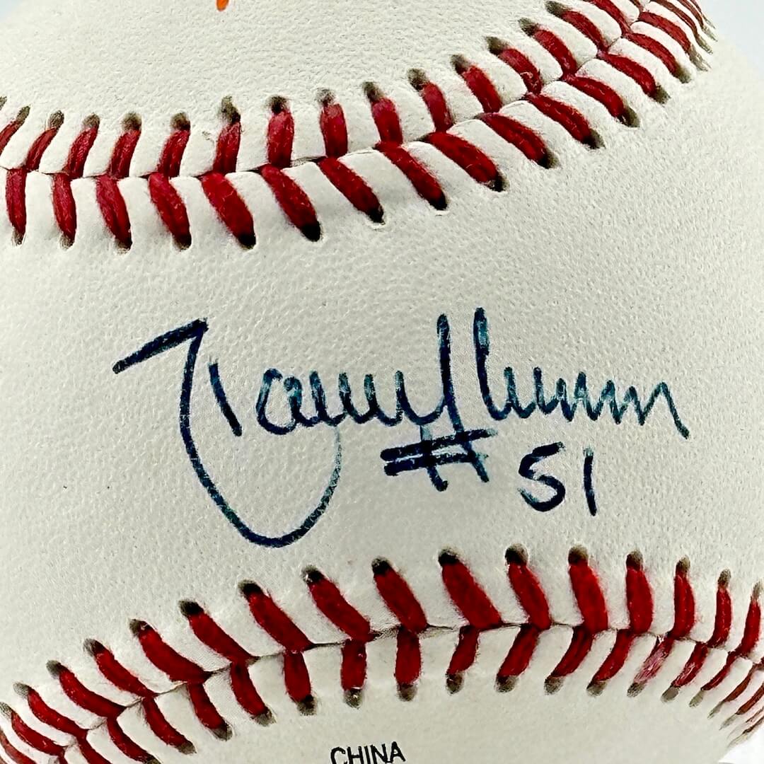 Close up of blue pen signature in narrow section between red stitching, the "sweet spot."