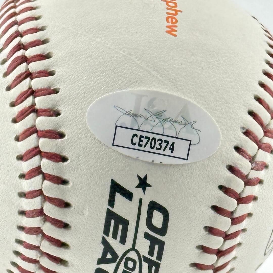 Close up of JSA authentication sticker next to MLB ball information stamp.