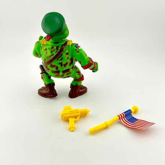 Toy figure in green camouflage with accessories on a white background