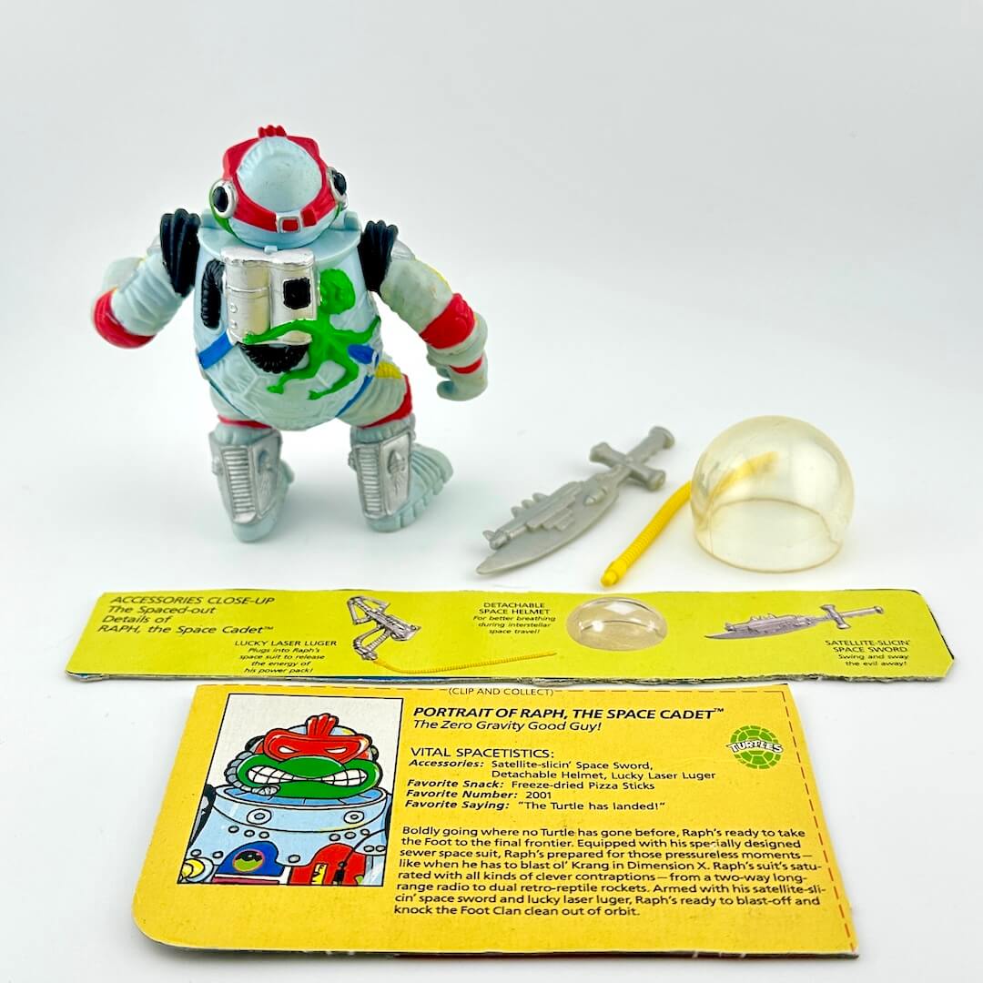 TMNT action figure with accessories and character card back against white background.