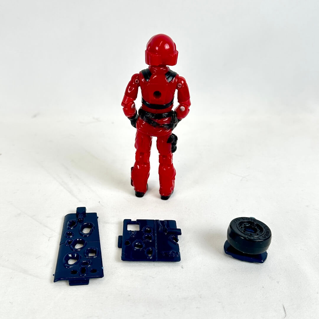 Red action figure with black parts on a white background