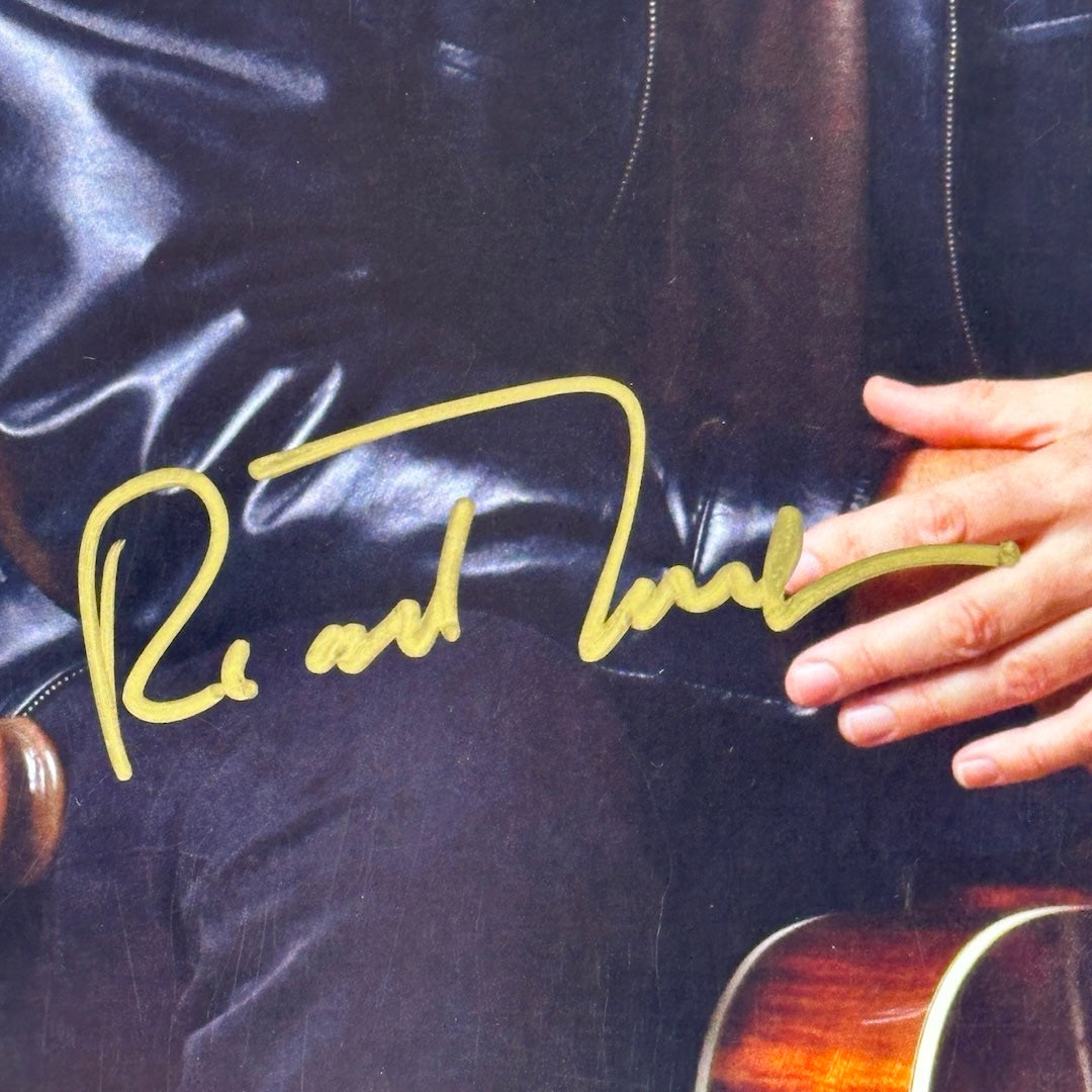 Close up of gold marker signature across the lap of Thompson's photo in center.