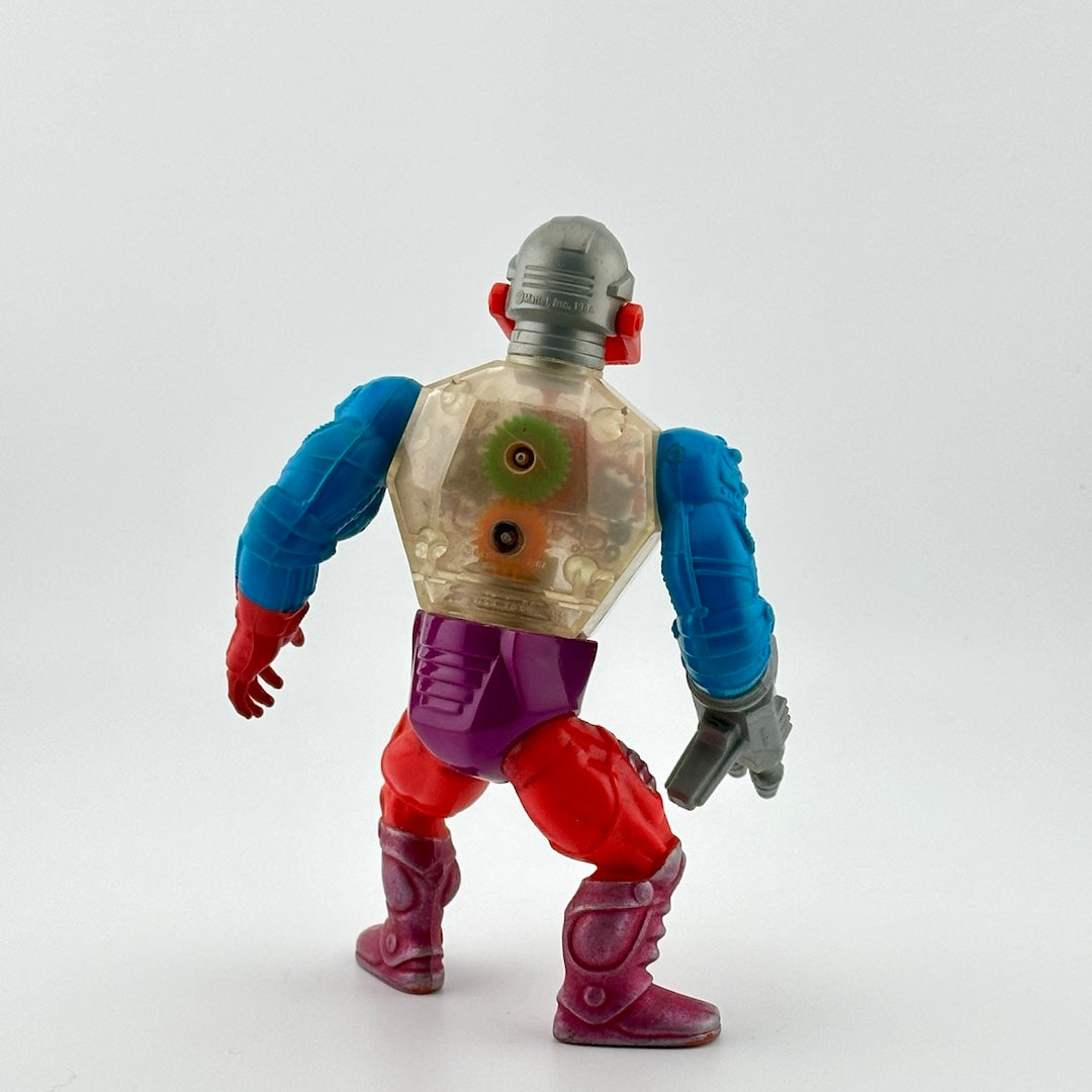 Robot figure back with clear chest, blue arms, and red legs. Has gun for hand and clear chest reveals inner gears.