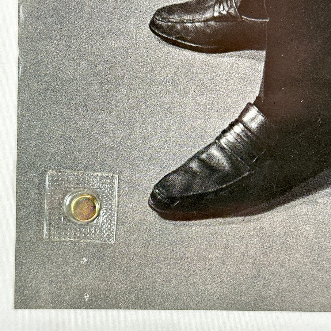 Bottom left corner with pin holes and wear to edge.