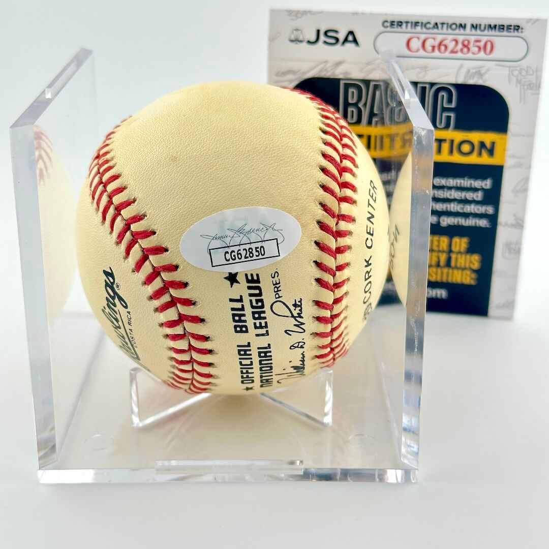 Signed baseball in clear display against white background with JSA certificate.