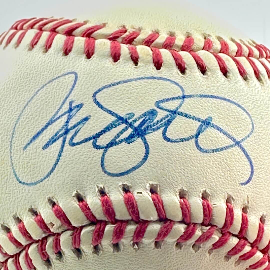 Baseball with a blue signature on a white background