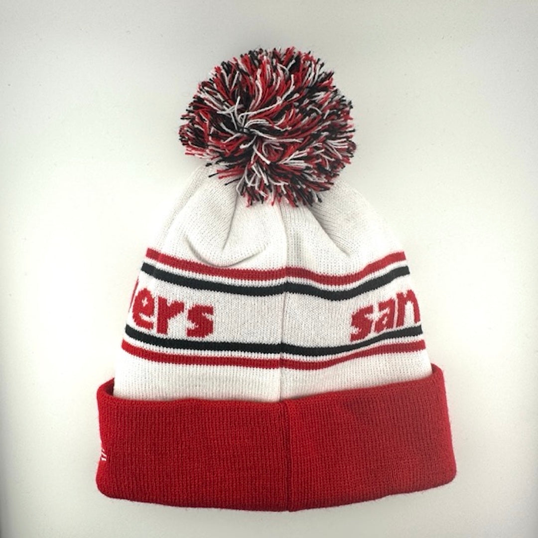 White knit cap with red/black stripes around red team name, 49ers logo in center of red cuff & red/black/white pom atop