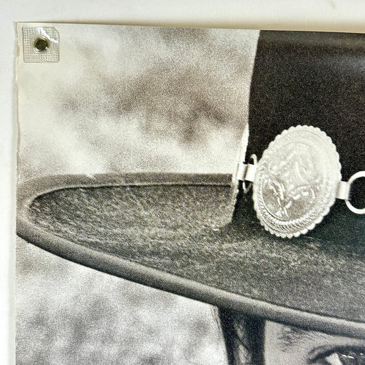 Top left corner of poster with wear along left edge