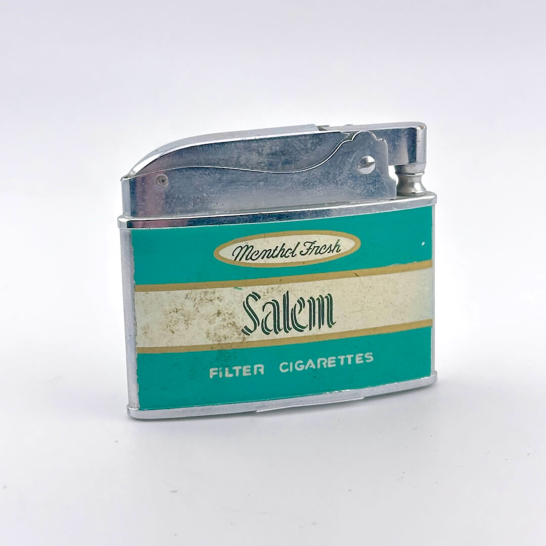 A vintage Salem filter cigarette lighter with a teal and cream label and a metallic silver body.