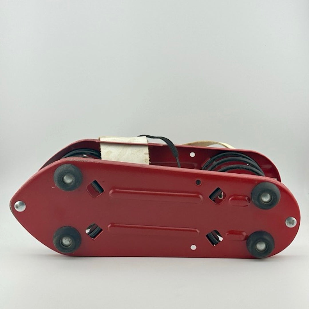 Bottom of red metal plate black rubber feet at four corners, no wear to bottom.