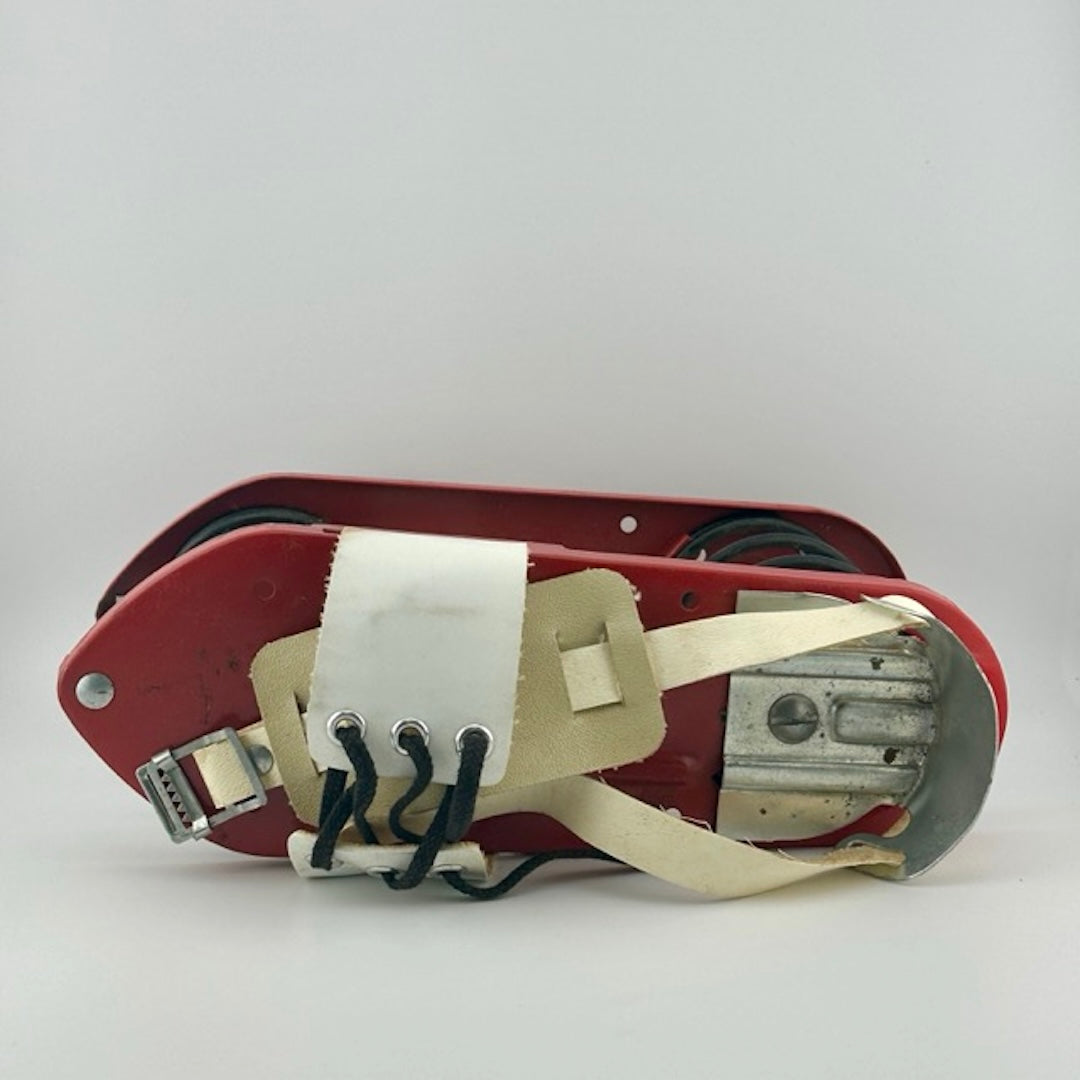 Top of shoe with white leather strap with black laces across top, with silver buckle and heel piece.
