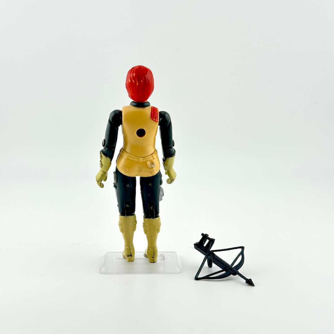Back of GI Joe action figure with an accessory against white background.