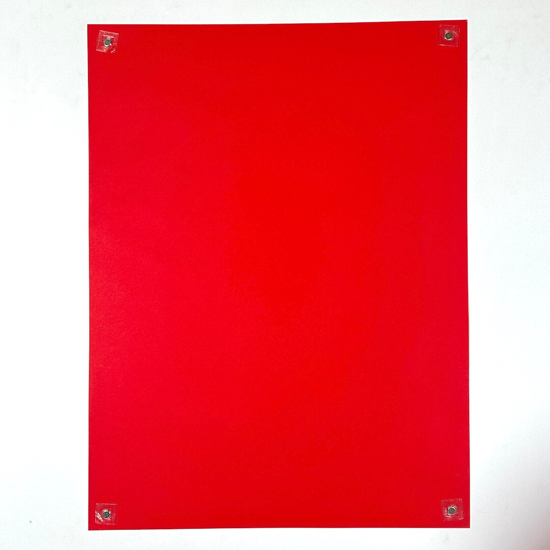 Backside of red poster against white background.