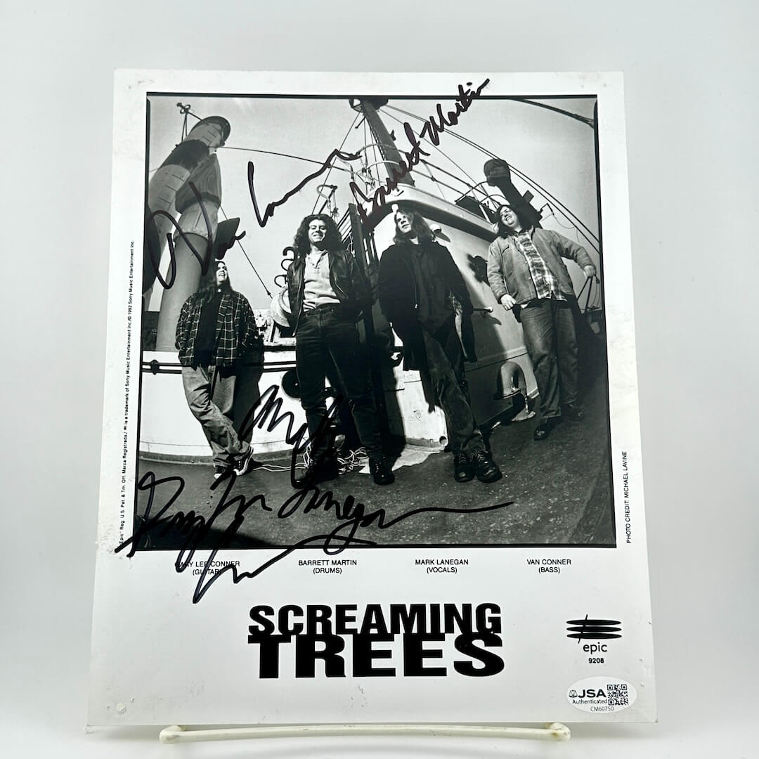Autographed photo of a band with 'Screaming Trees' at the bottom on a white background