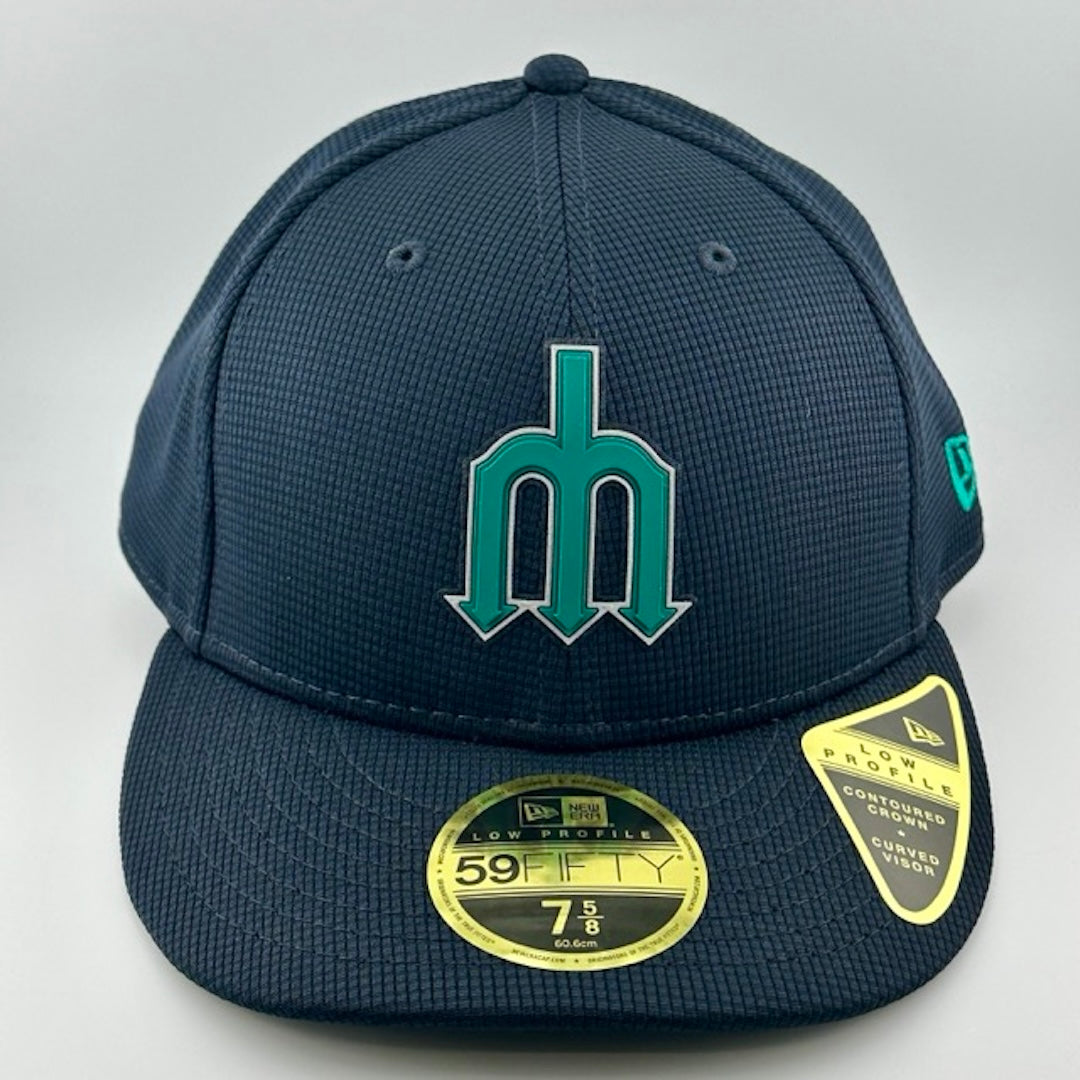 Baseball cap with navy face, brim & back. Teal & white Seattle Mariners trident logo center-face. Gold sticker on brim.