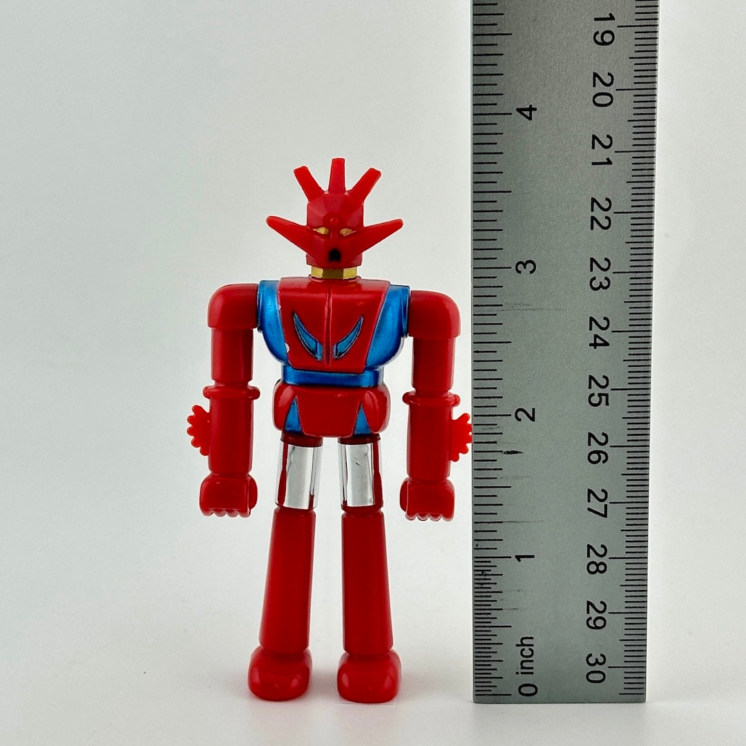 Image of 3.5 inch robot action figure standing next to ruler to show figure height.
