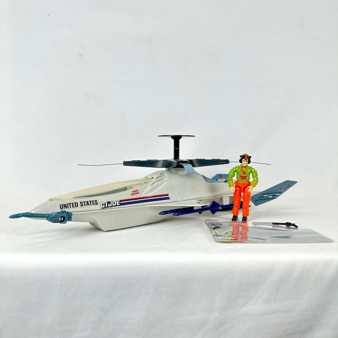 Toy helicopter with 'United States' text and a figure in a green jacket and orange pants on a white background