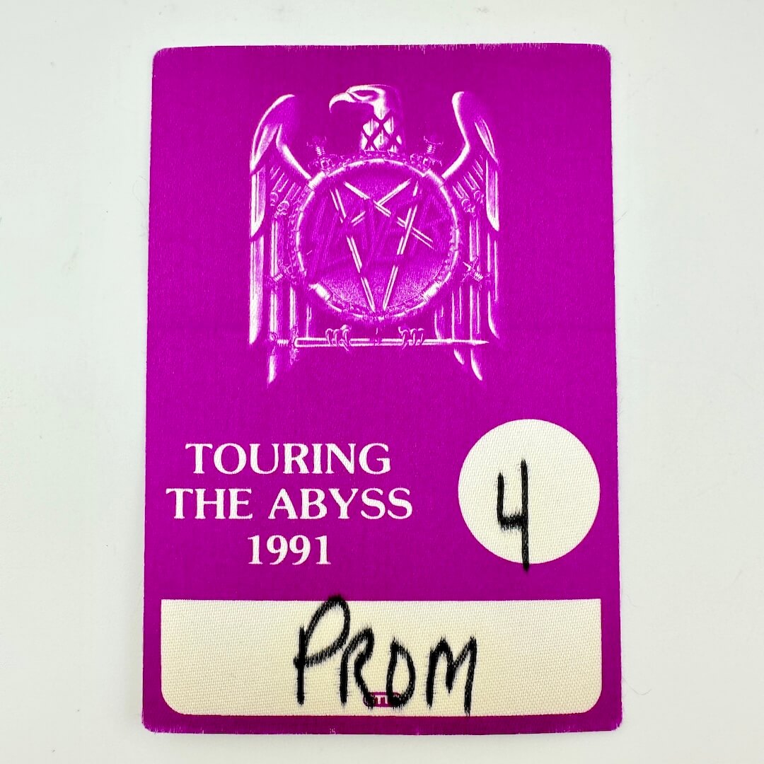 Purple concert ticket with 'Touring the Abyss 1991' text and logo on a white background
