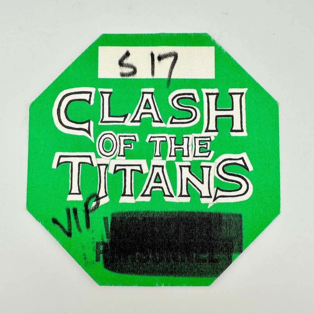 Green 'Clash of the Titans' sticker with text on a white background